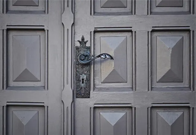 Paneled door with a classic handle