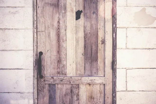 Rustic wooden door set in a stone wall