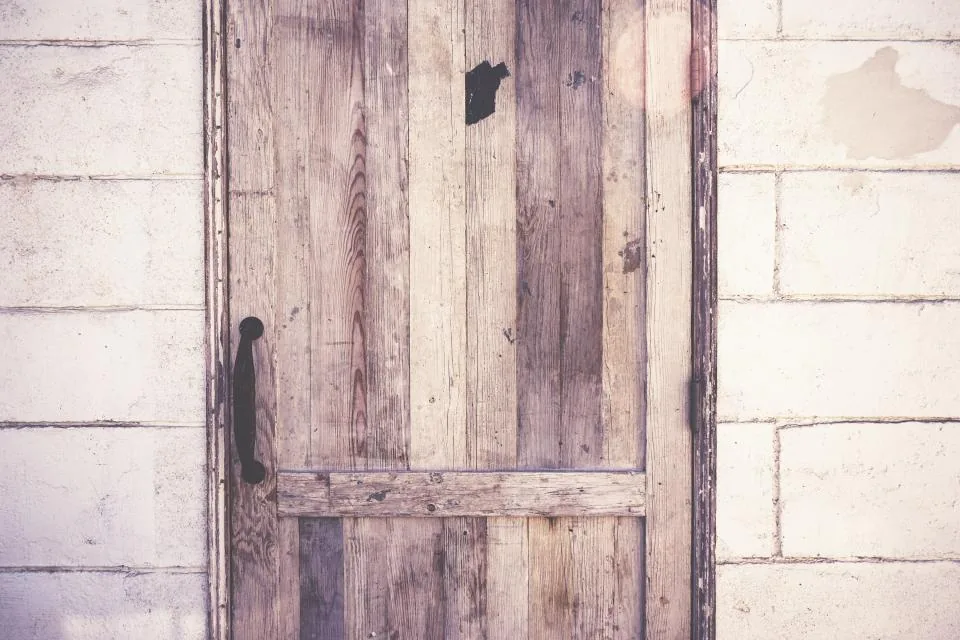Rustic wooden door set in a stone wall